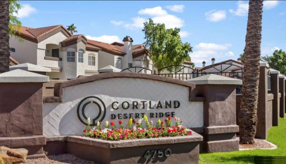 A sign for cortland desert ridge is in front of a building