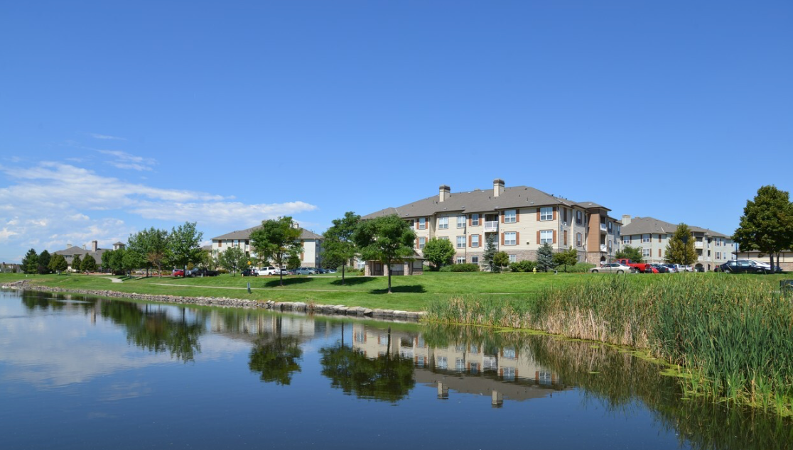 A large building is sitting next to a body of water.