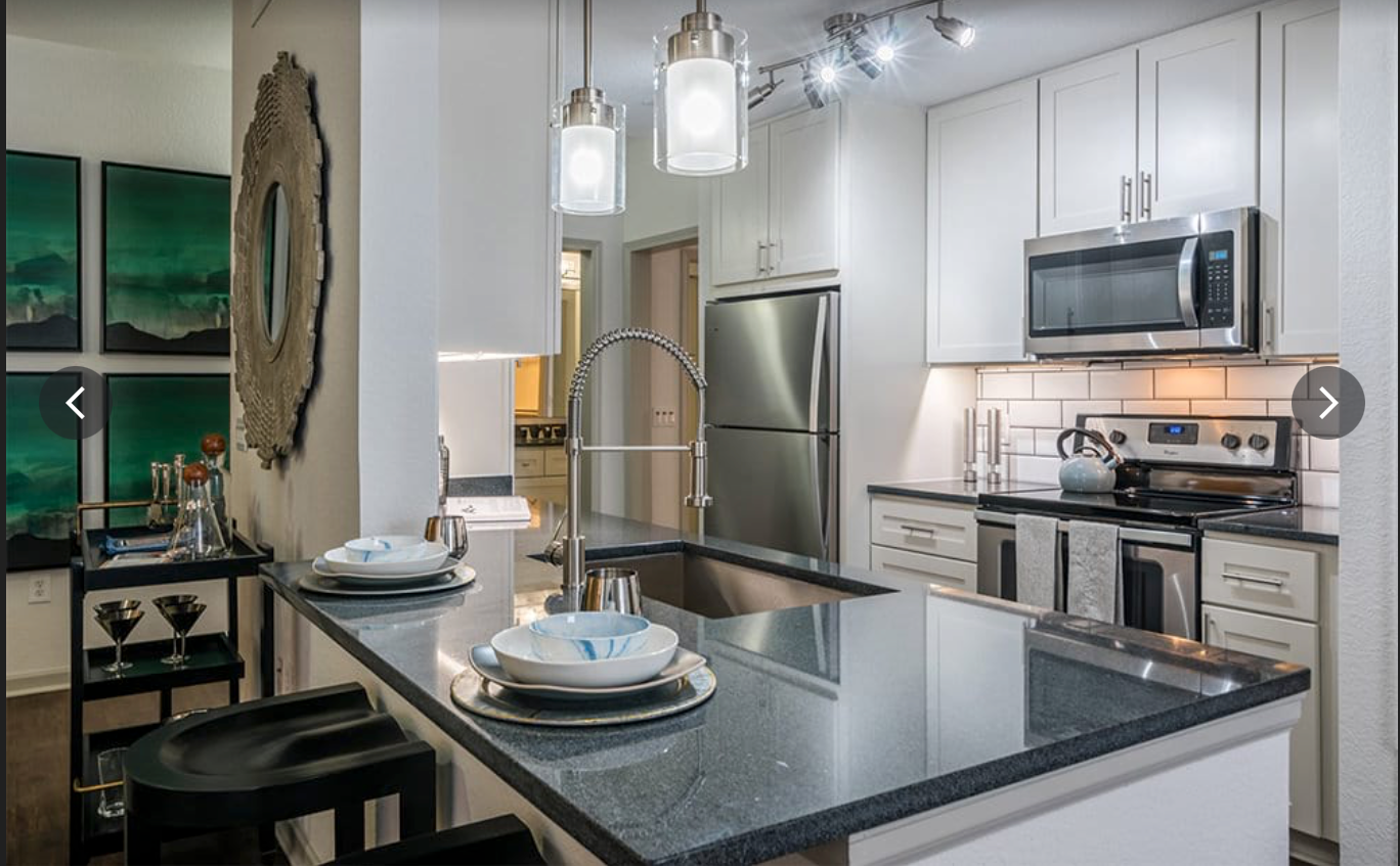A kitchen with stainless steel appliances and a granite counter top.