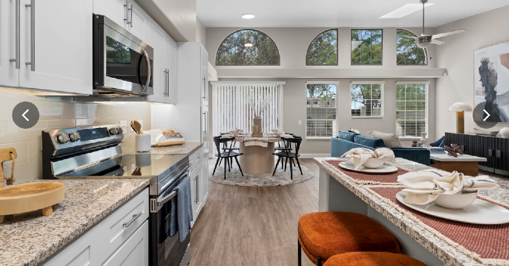 A kitchen with stainless steel appliances and granite counter tops.