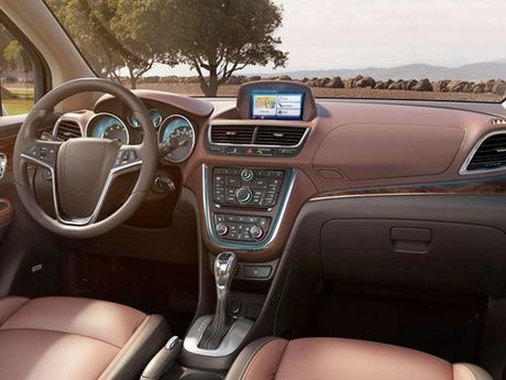 The interior of a car with brown leather seats and a steering wheel