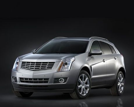 A silver car is parked in front of a black background