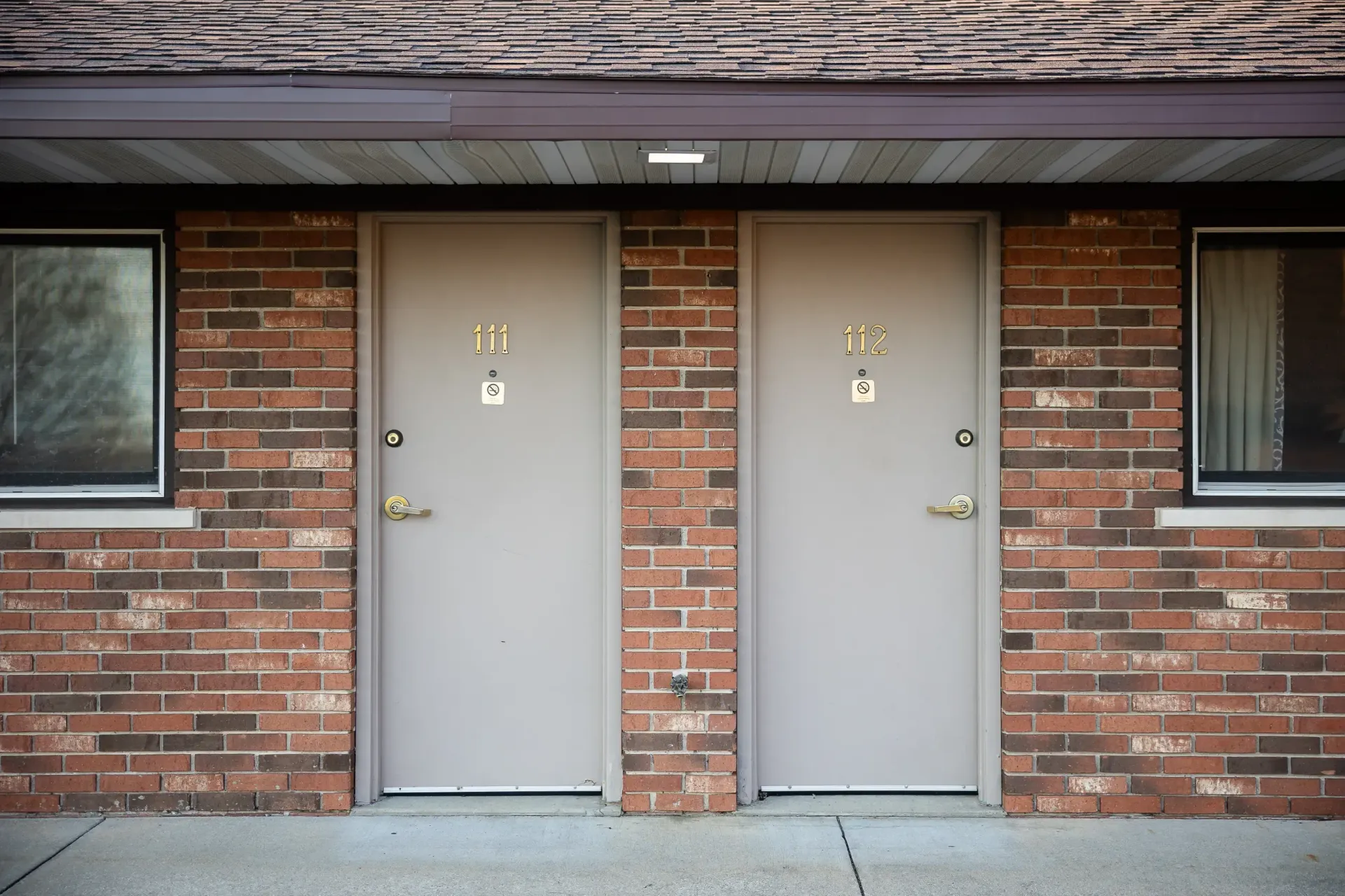 A brick building with two doors and a window