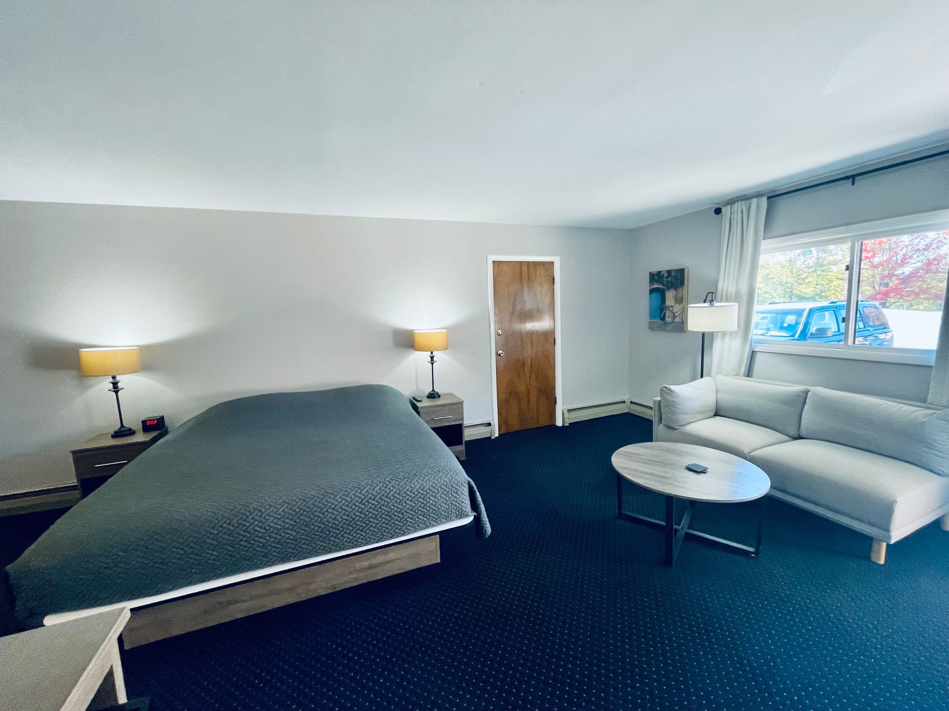 A hotel room with a bed and a toilet