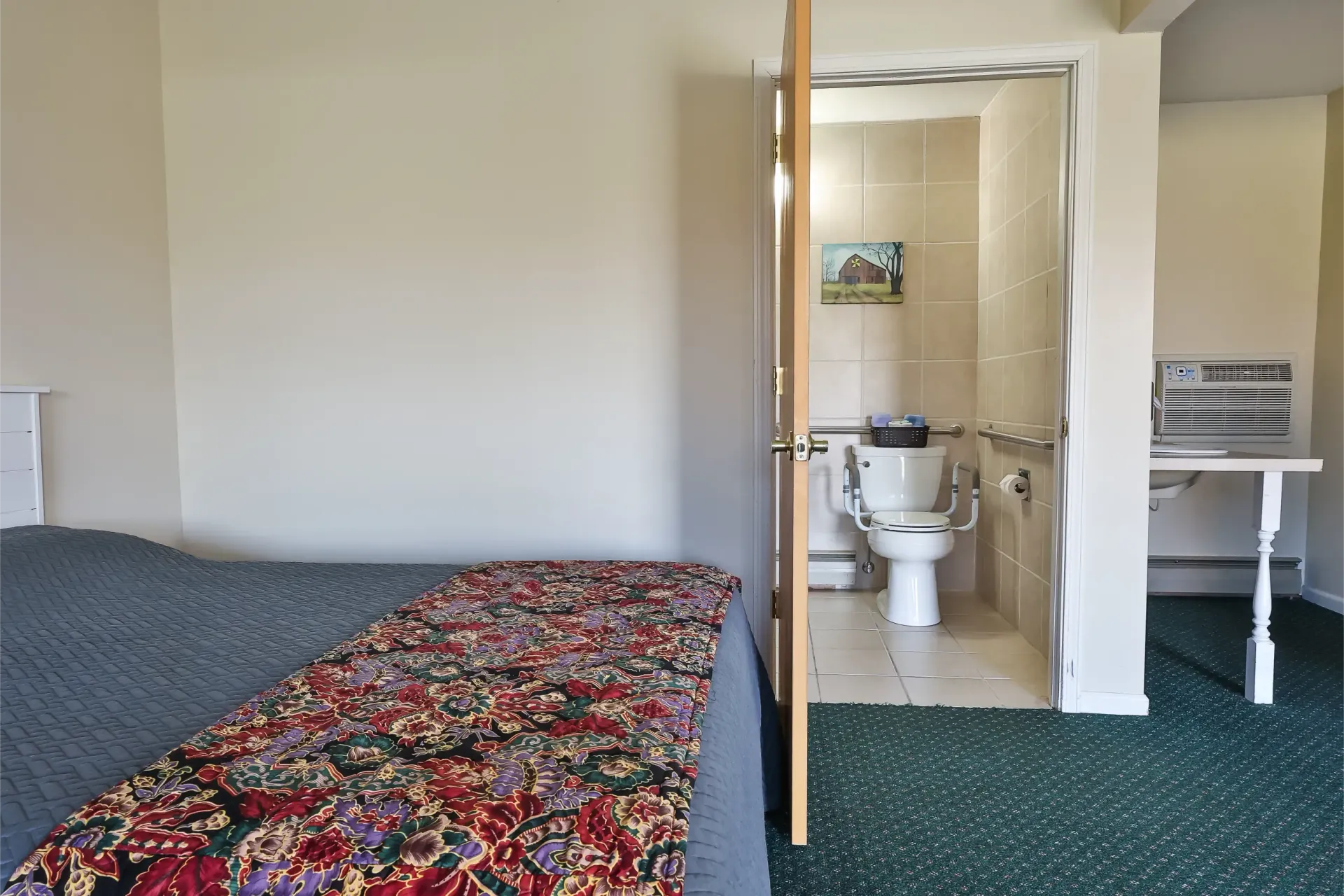 A hotel room with a bed and a toilet.
