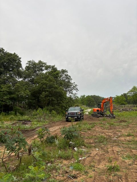 Debris hauling crew member reviewing job at rural Illinois property