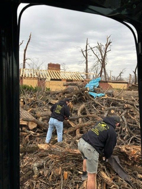 Debris hauling crew loading dump truck at Kankakee County property
