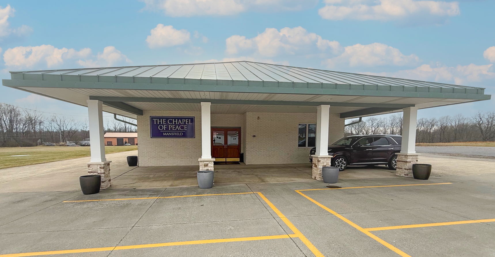 A brick building with a sign in front of it.