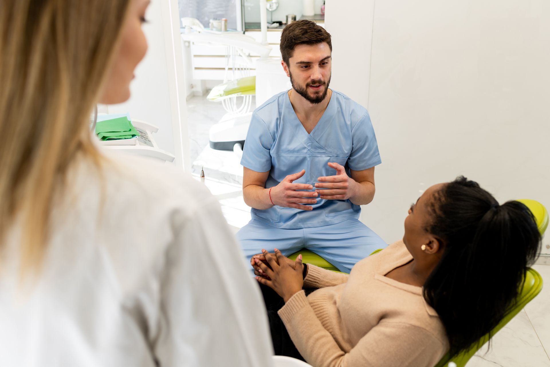 Doctor sitting down next to patient, explaining details of treatment and going over results