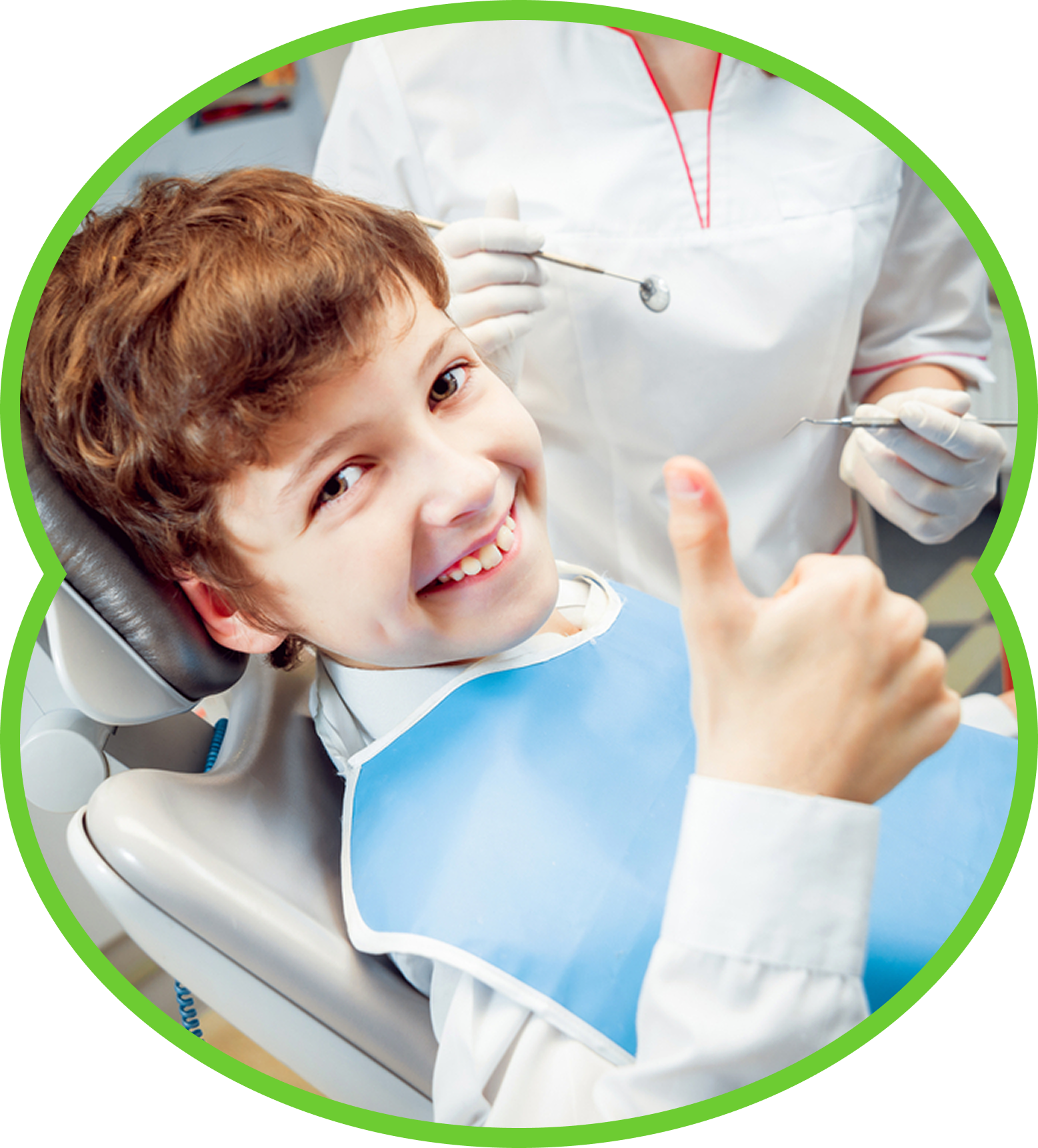 Smiling child in a dental chair giving a thumbs-up during a dentist visit