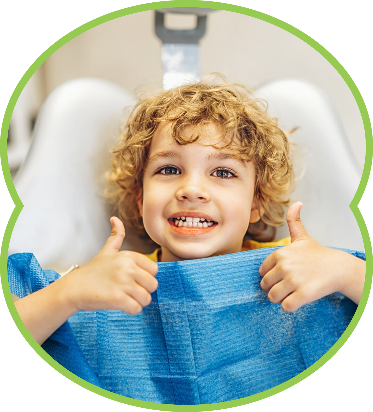 Smiling child giving two thumbs up from inside a blue dental chair