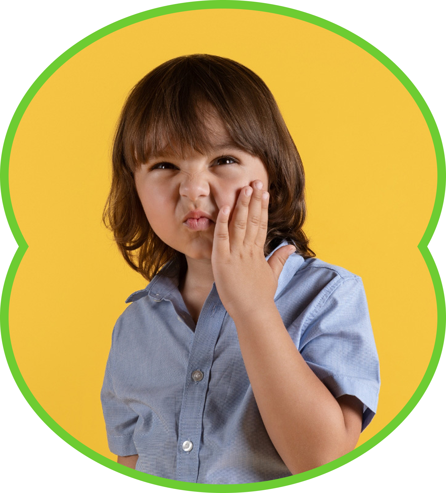 Child grimacing and touching cheek against a yellow background with a green border