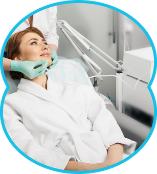Patient in a dental chair while a clinician examines her mouth with gloved hands in a bright clinic