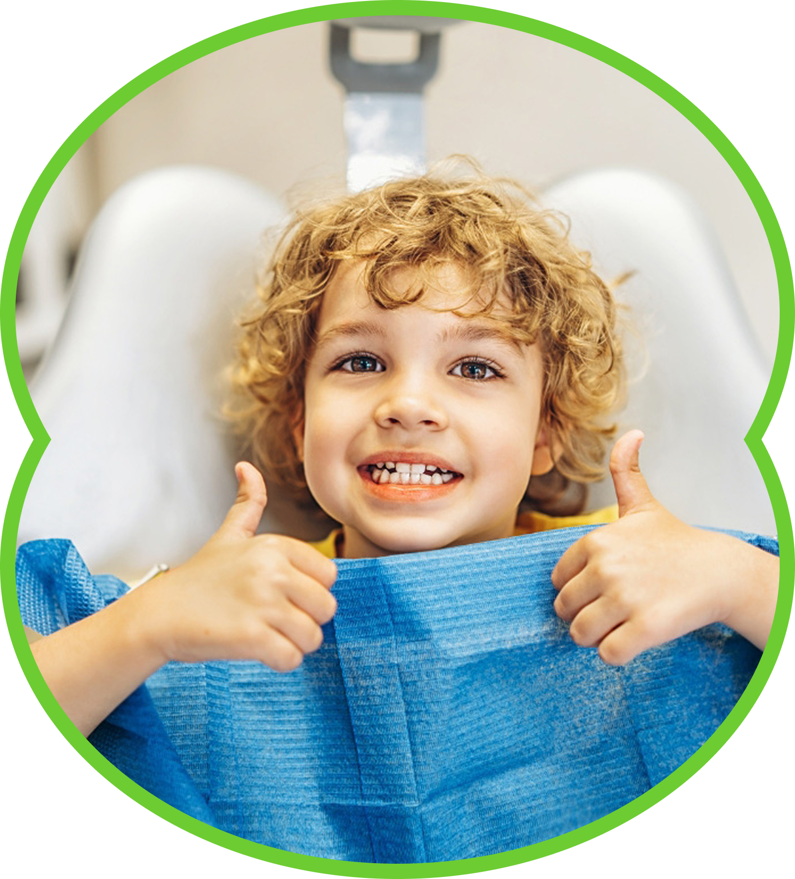 Smiling child giving thumbs up while sitting in a blue dental chair