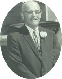 A black and white photo of a man in a suit and tie