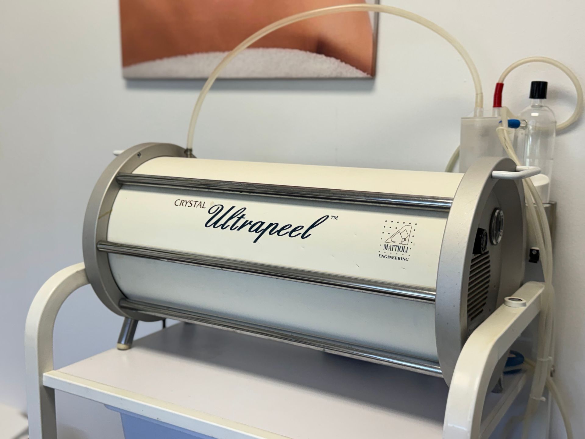 Whirlpool cylindrical medical device on a cart, with tubing and control panel in a clinical setting