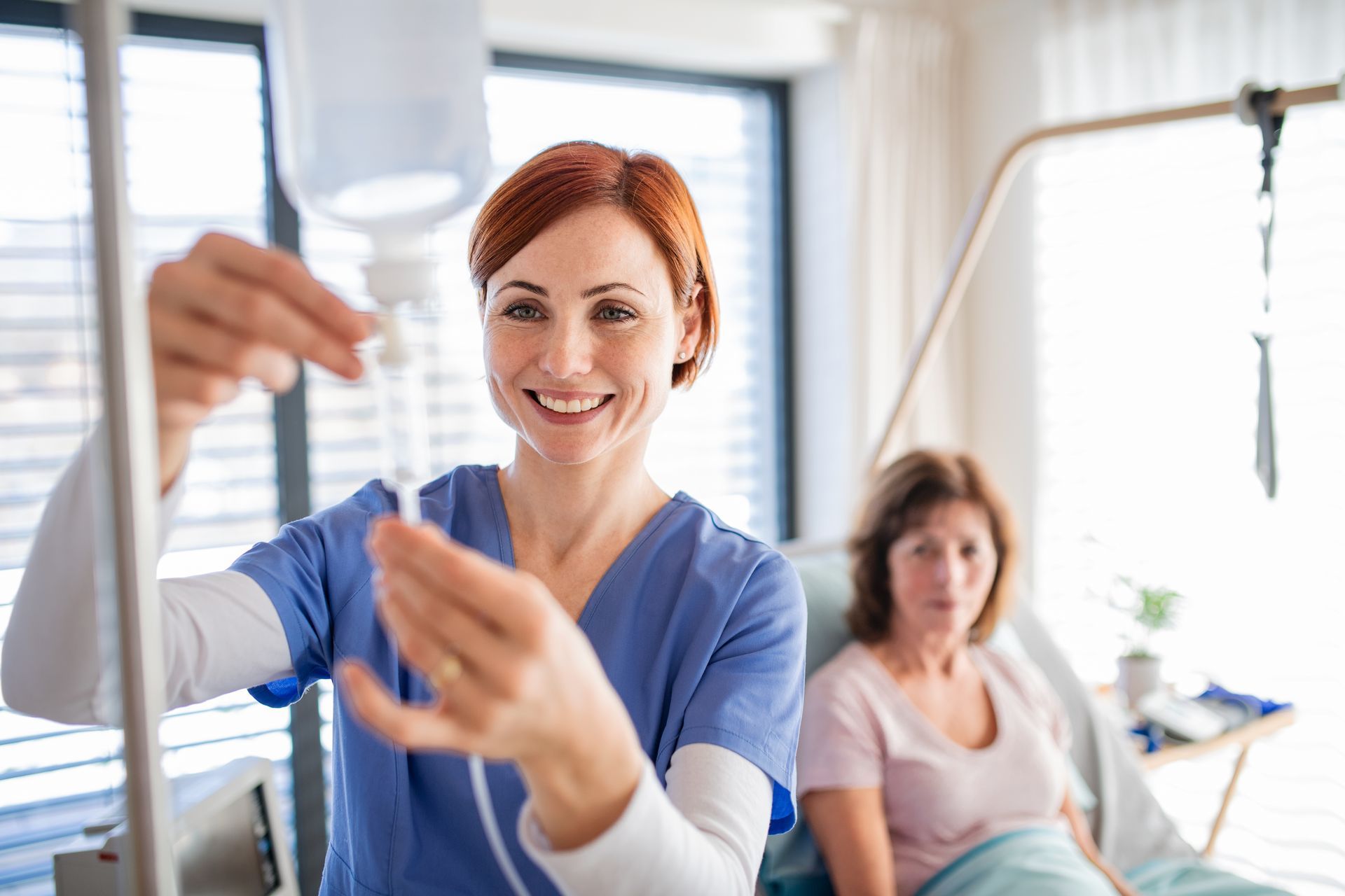 Therapist guiding arm exercise with smiling patient in a bright clinic room