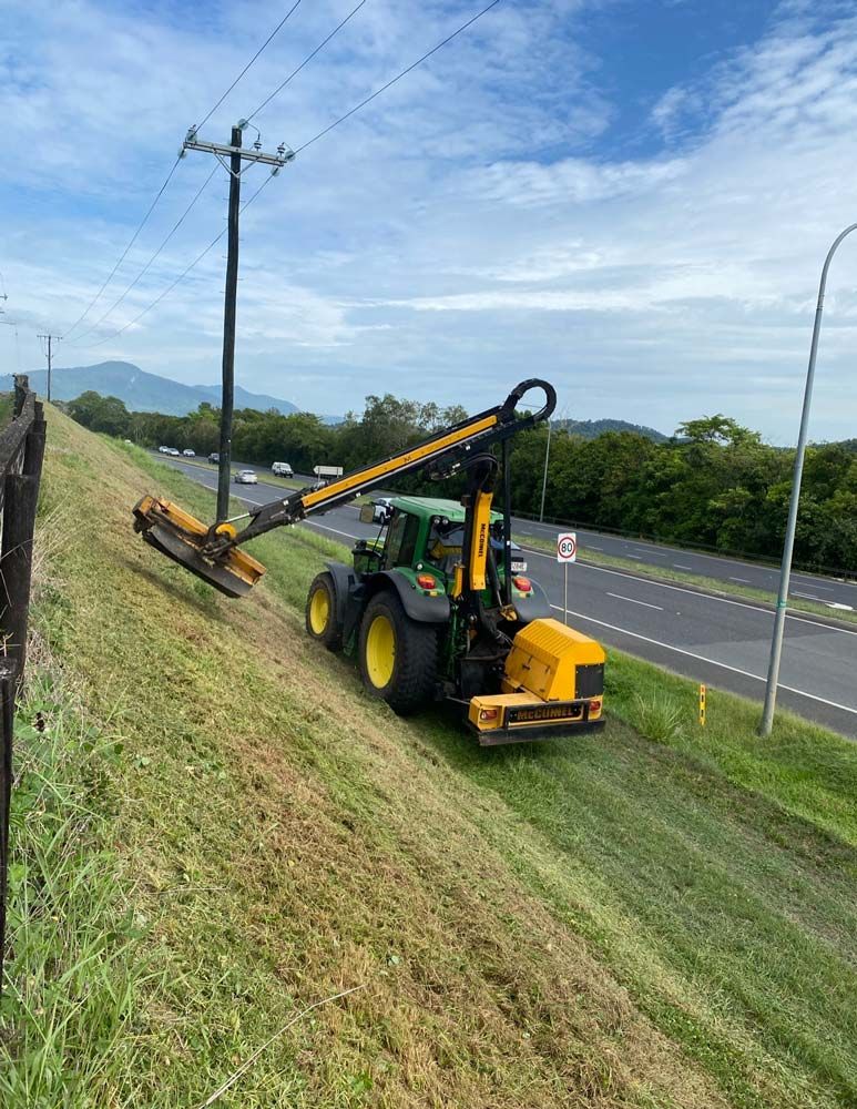 Mowing Inclined Field Near the Road — J.A. Slashing in Cairns, QLD