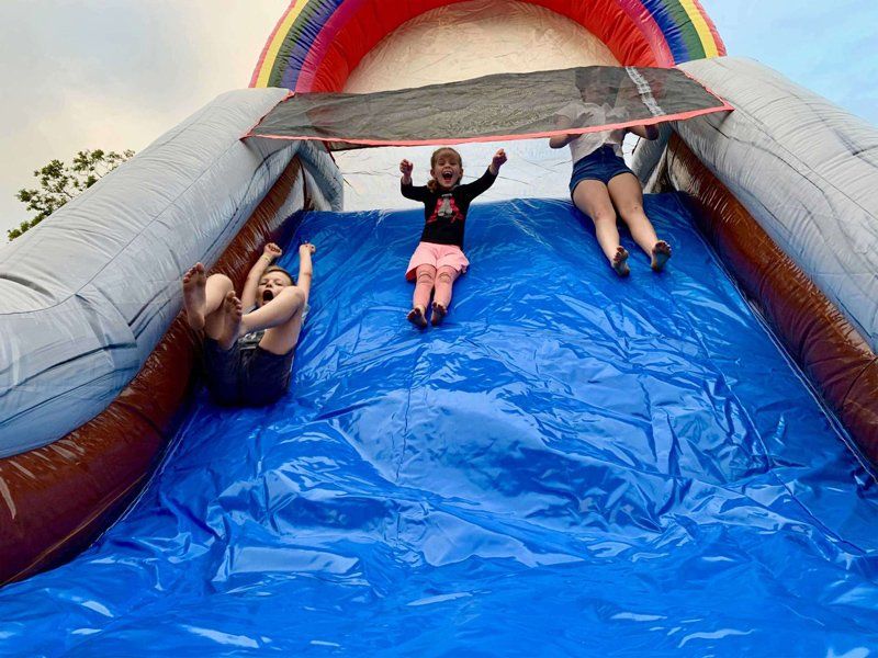 Children sliding together — Inflatable Activities in Gympie, QLD