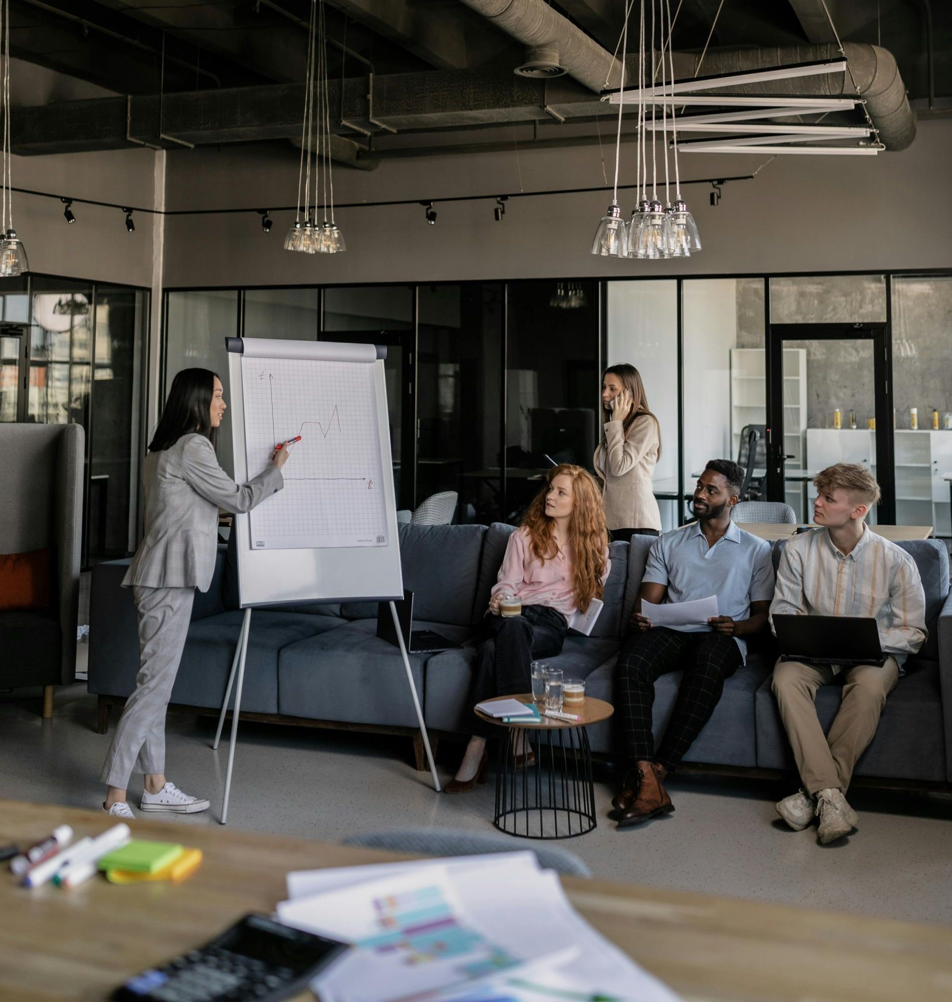 A woman is giving a presentation to a group of people