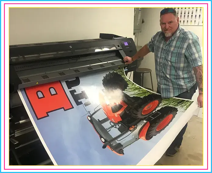 A Man Holding a Large Poster of A Tractor