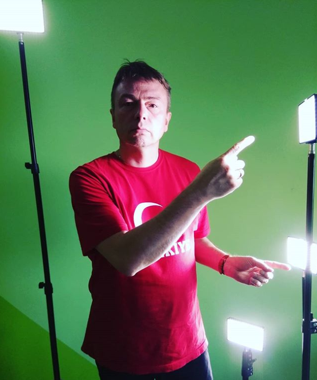 A man in a red shirt is pointing at something