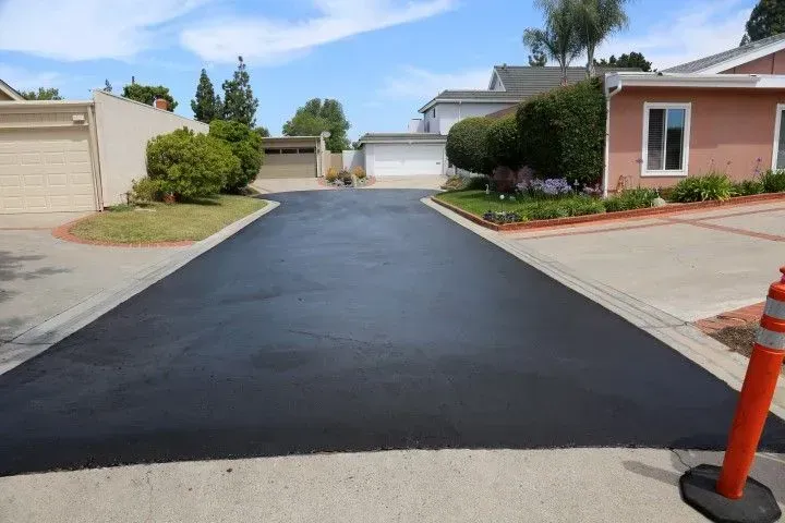Freshly sealed black asphalt driveway.