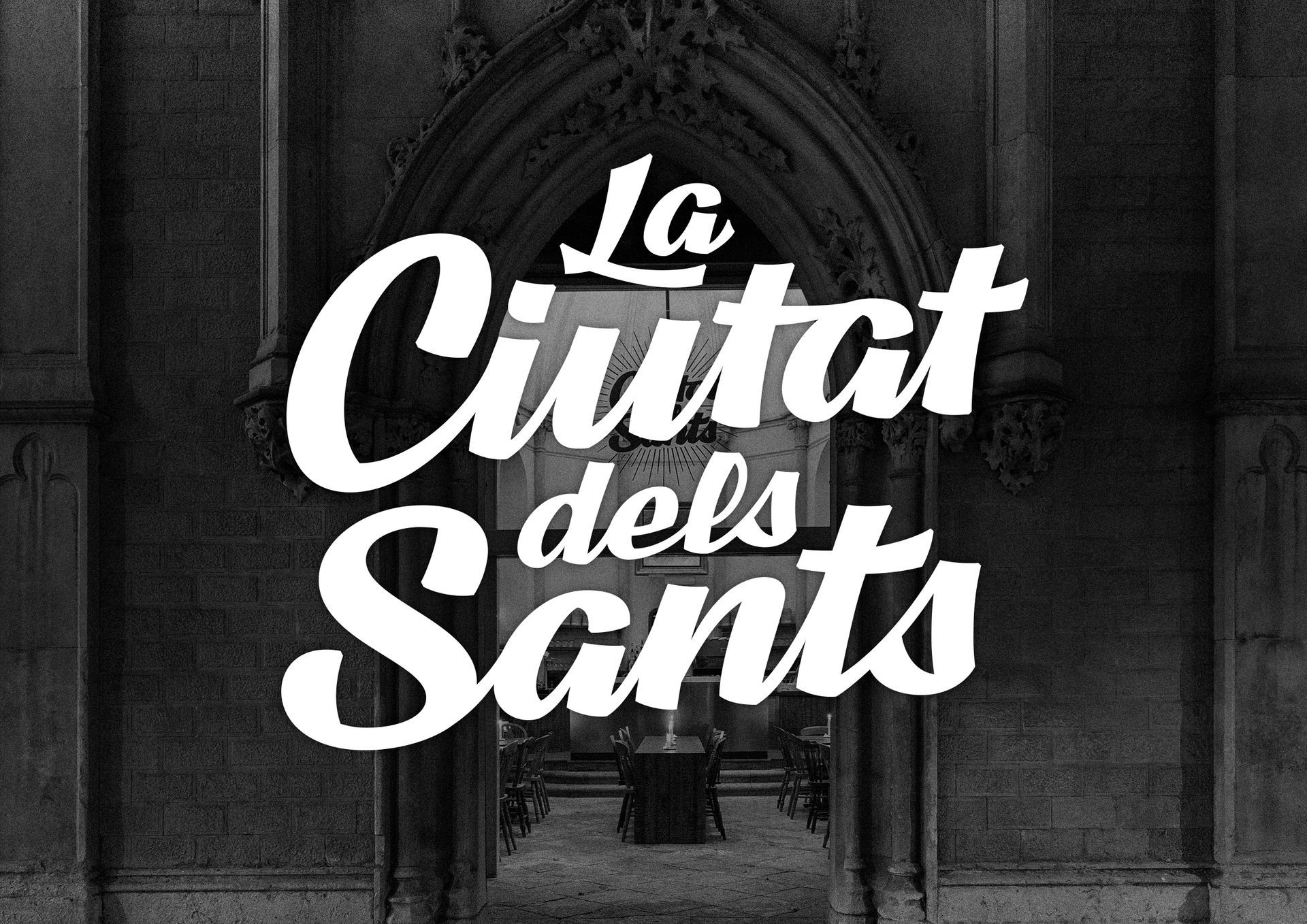 Black-and-white poster reading “La Ciutat dels Sants” over a city archway background