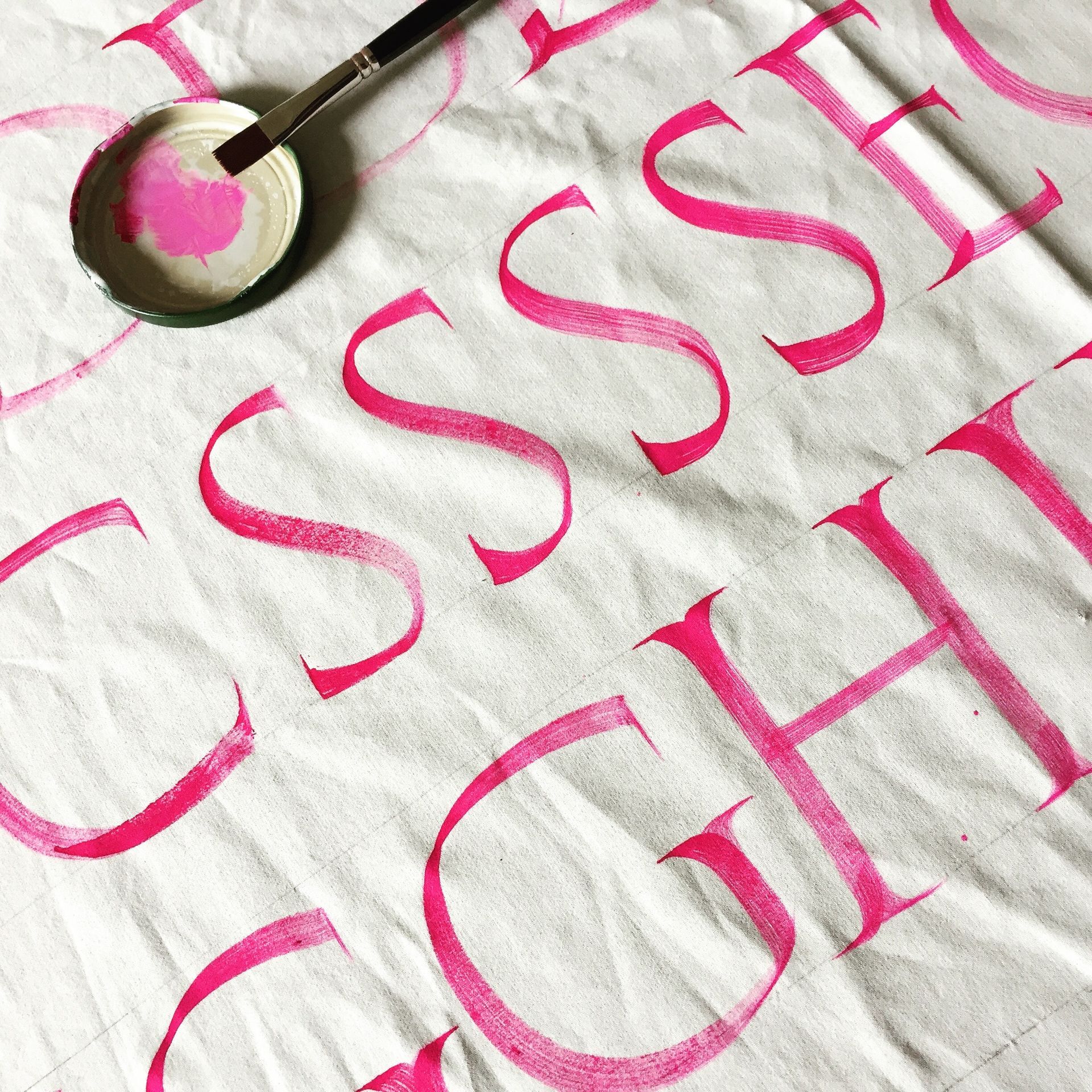 Image in colour of brush roman capitals.