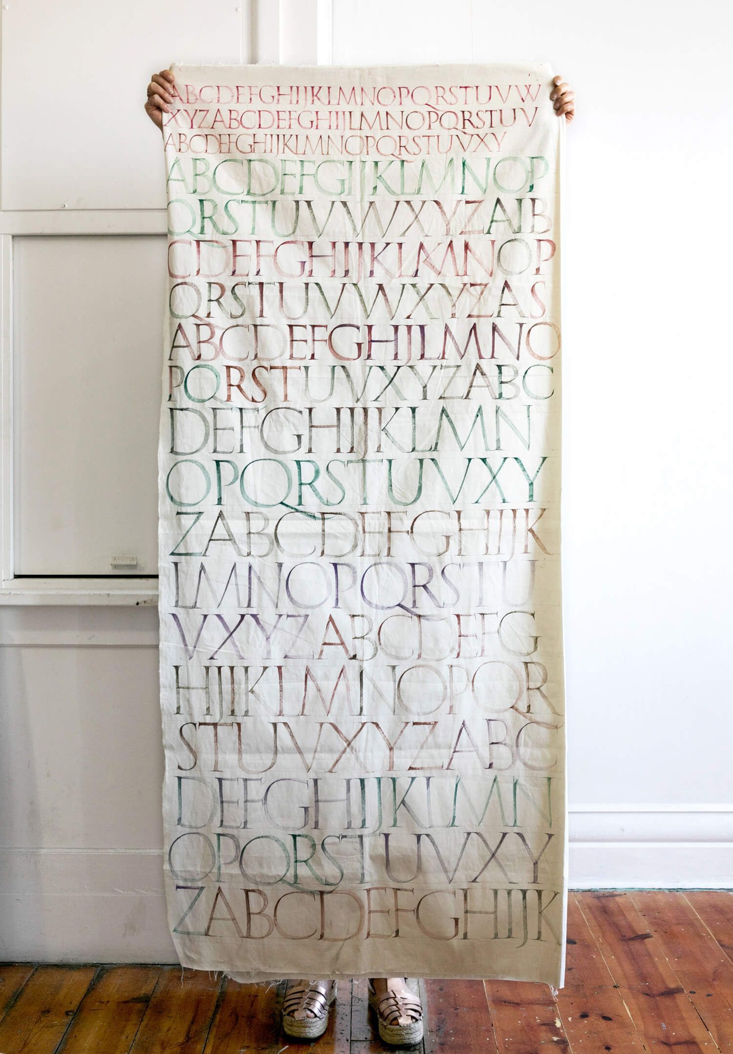 Brush Roman Capitals design on fabric. Two metres long.