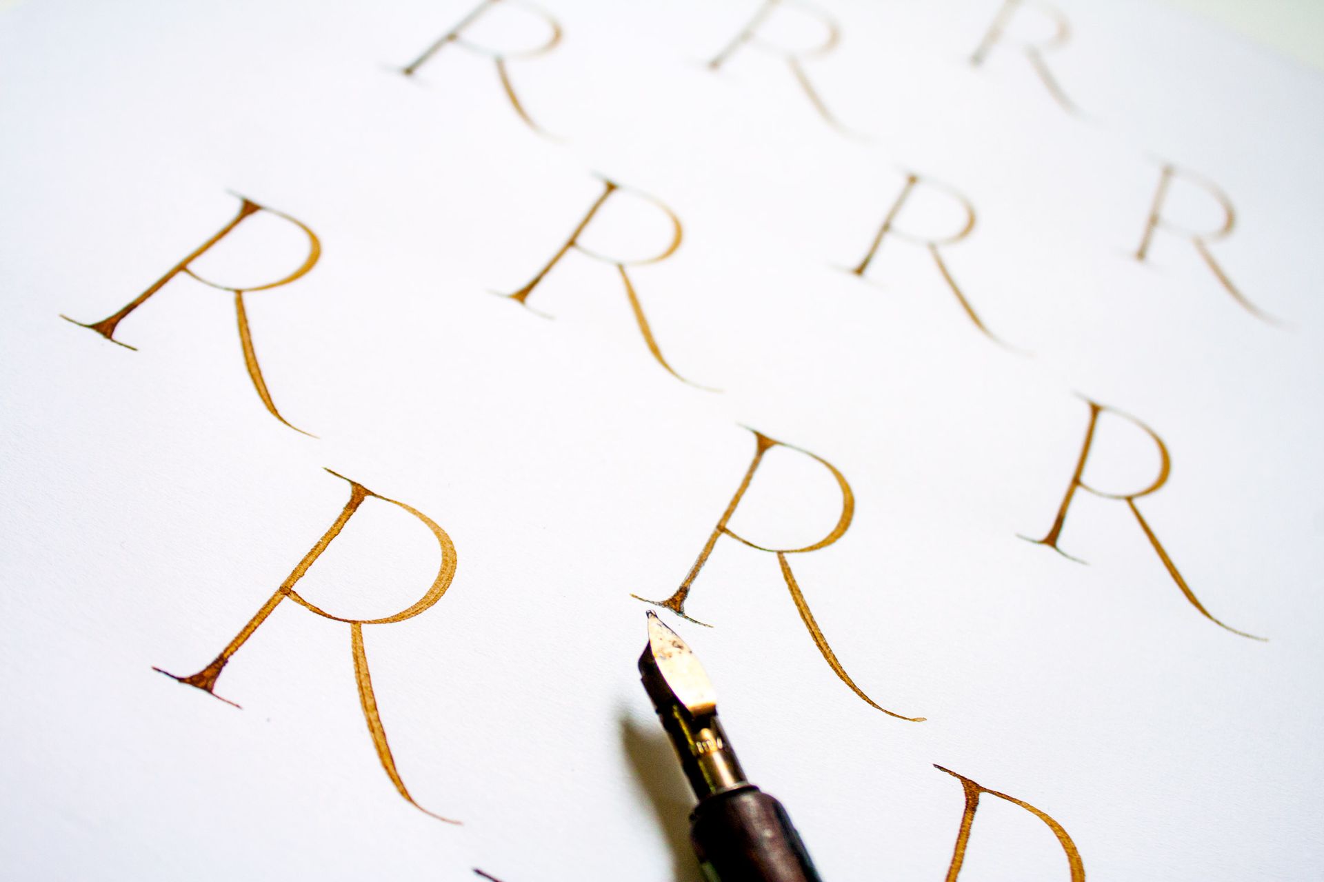 An image using Copperplate calligraphy to display the message 'short exit strokes' with a white and green background.