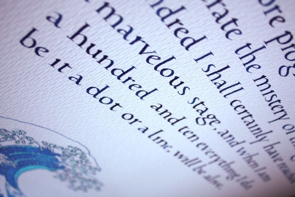 Close-up of a tilted book page with decorative text and blue illustration details