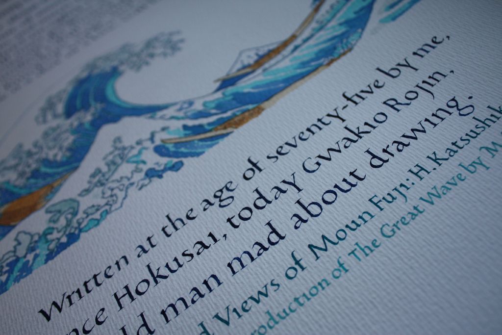 Close-up of a book page with blue decorative illustration and angled black text.