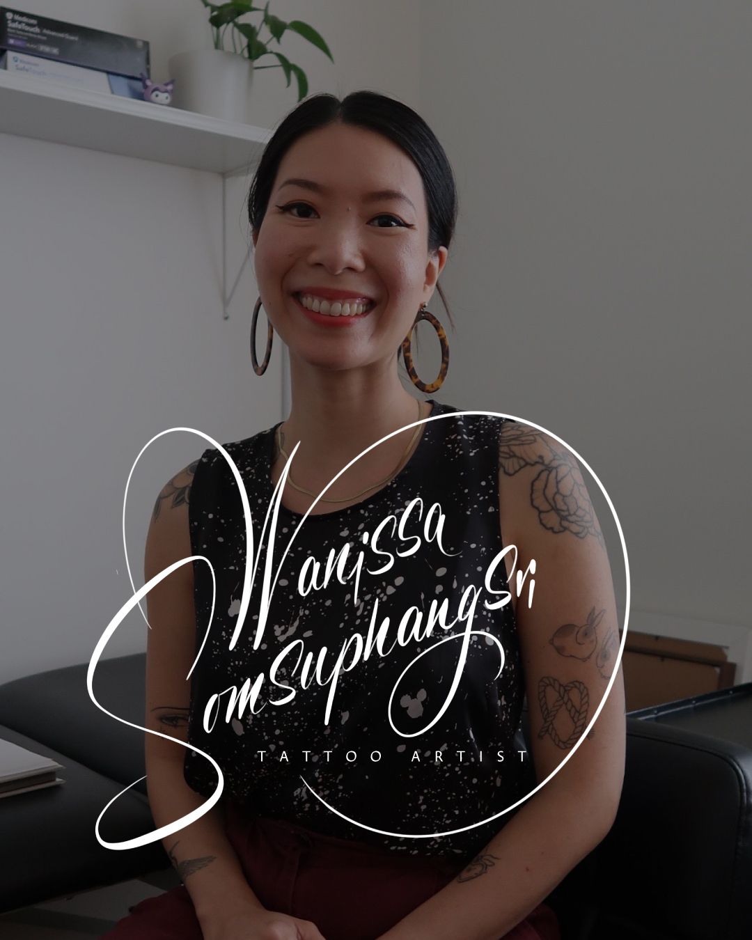 Smiling person in a black floral dress sits indoors, with white script text overlay on the image.