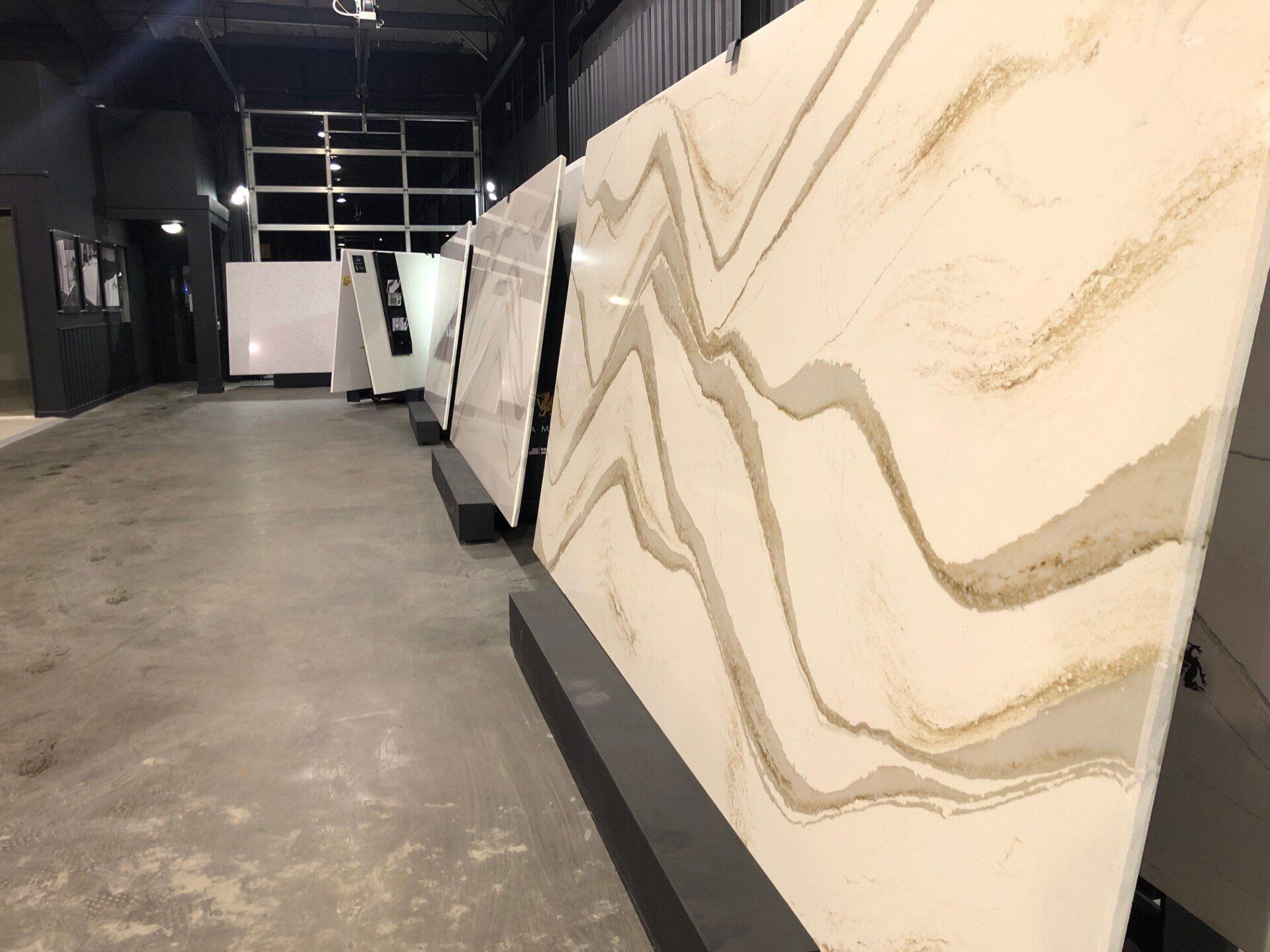 A row of marble slabs sitting on top of each other in a showroom.