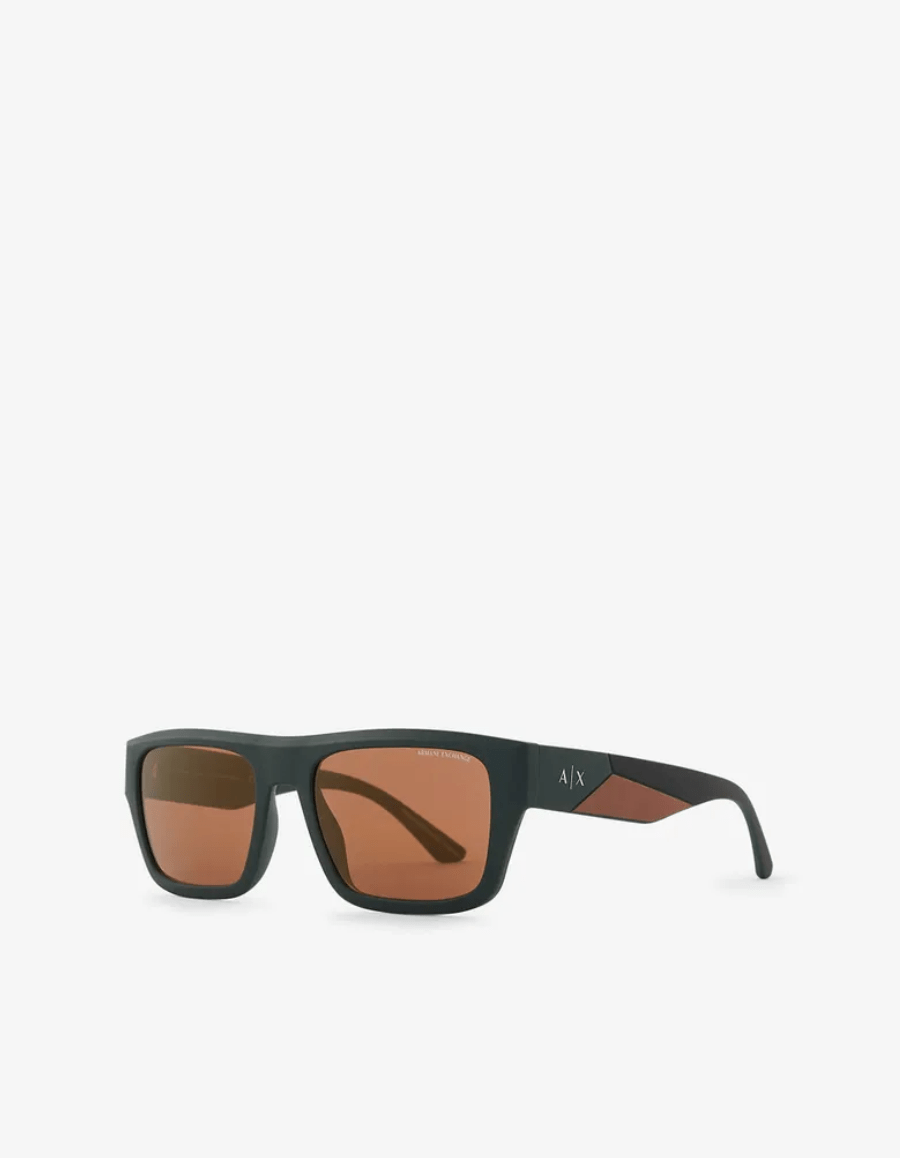 A pair of sunglasses with brown lenses on a white background.