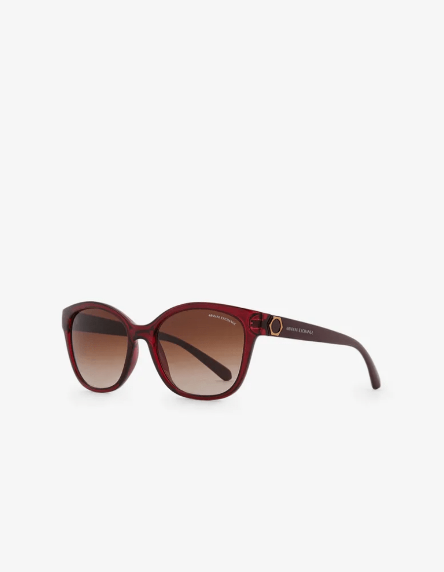 A pair of red sunglasses with brown lenses on a white background.