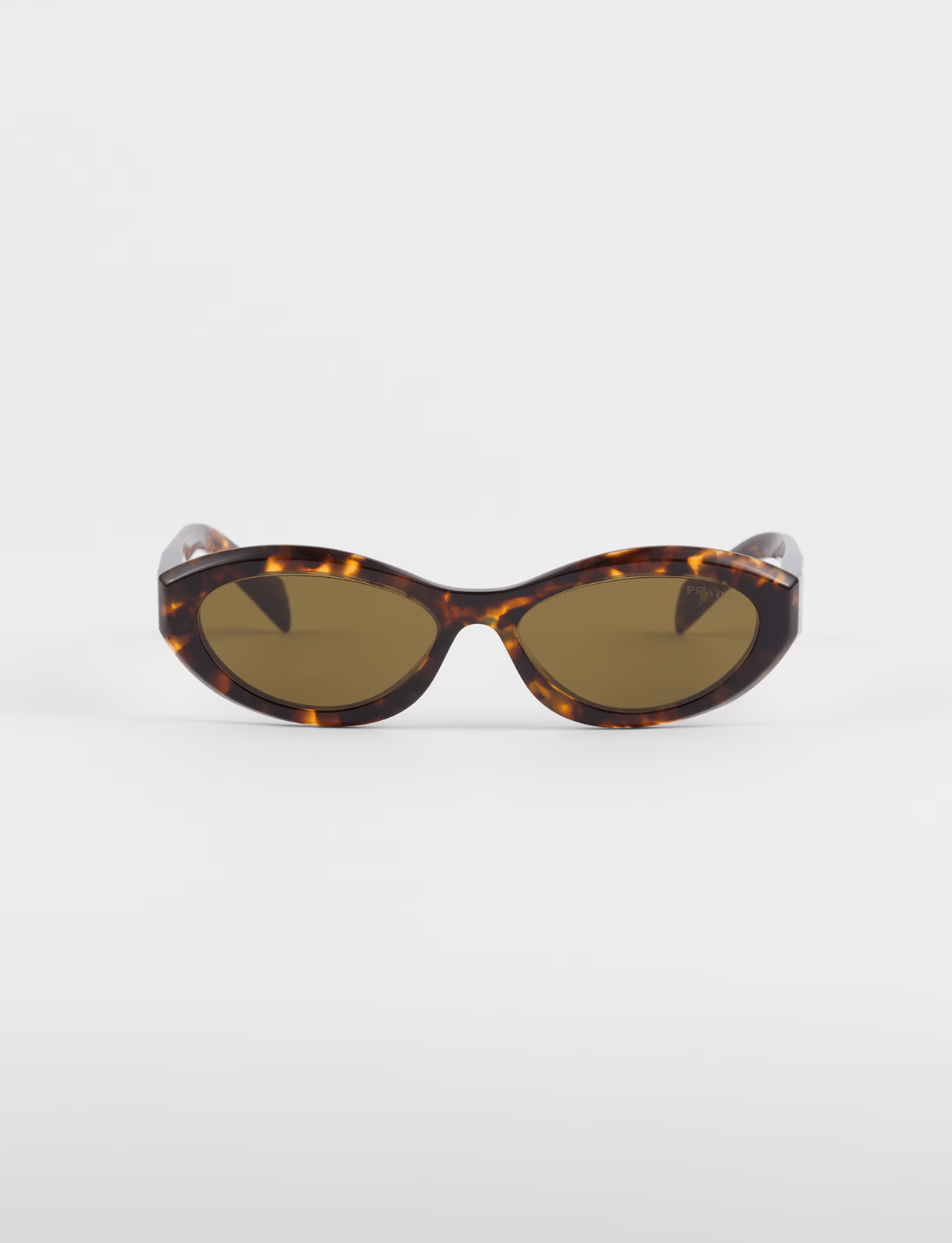 A pair of brown sunglasses on a white background.