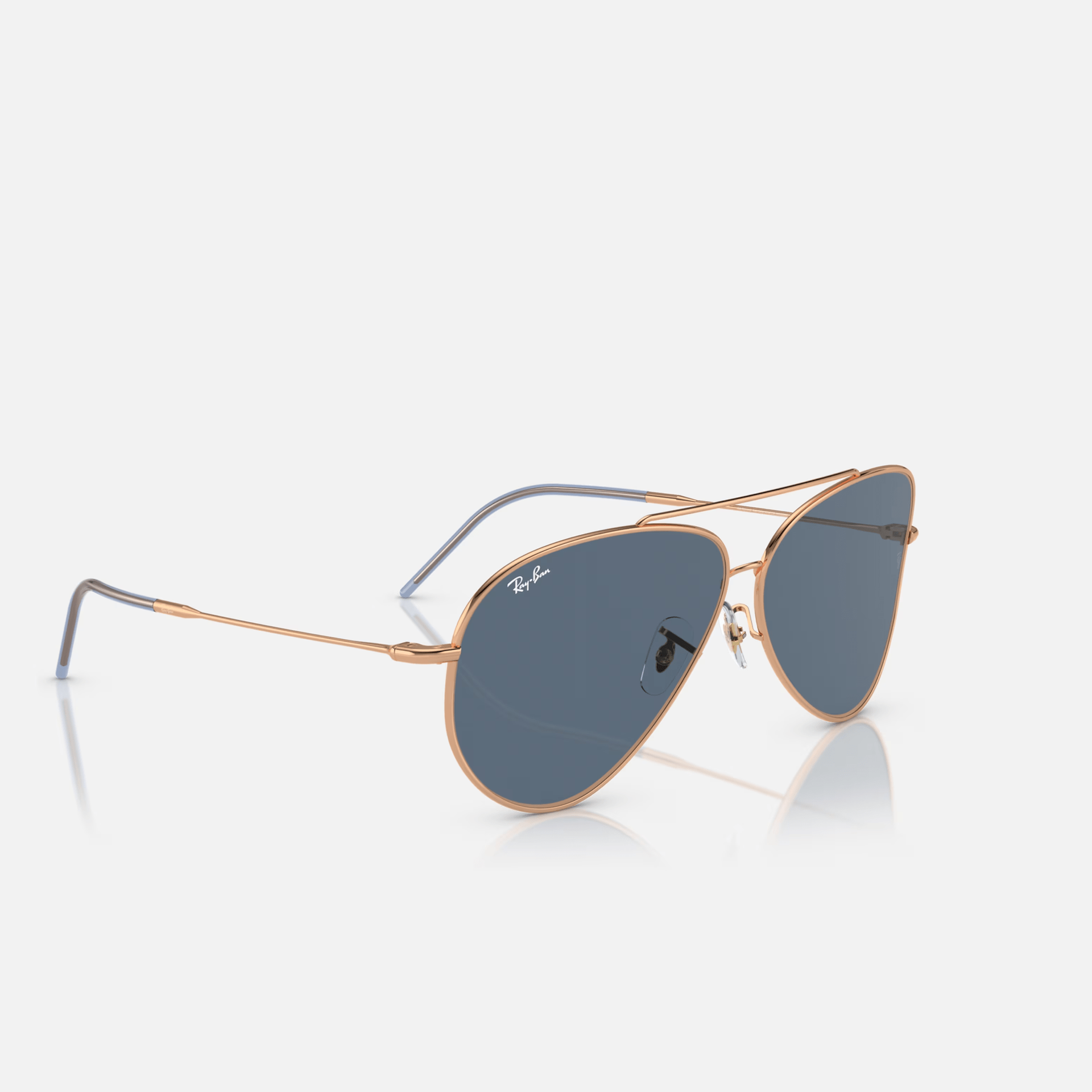 A pair of ray-ban sunglasses on a white surface