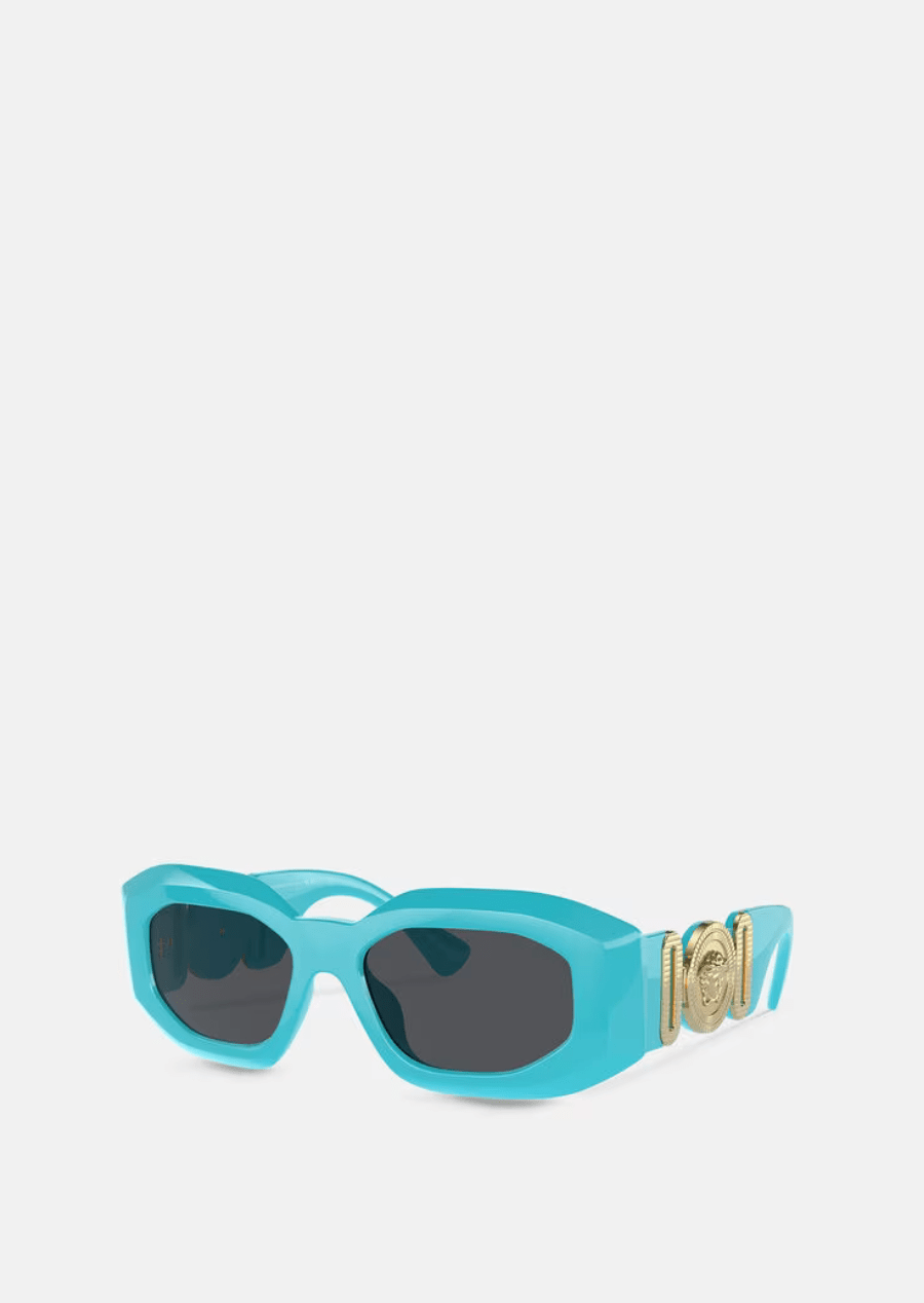 A pair of blue sunglasses with a gold buckle on a white background.