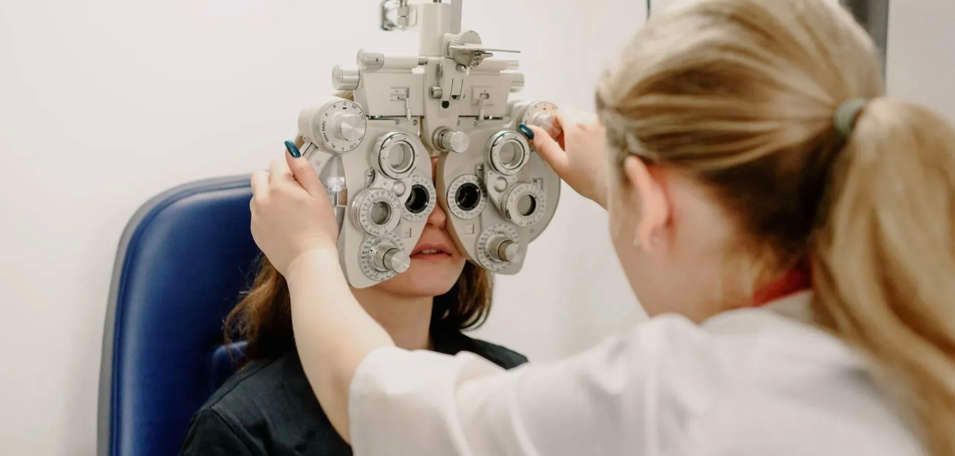 A woman is getting her eyes checked by an ophthalmologist.