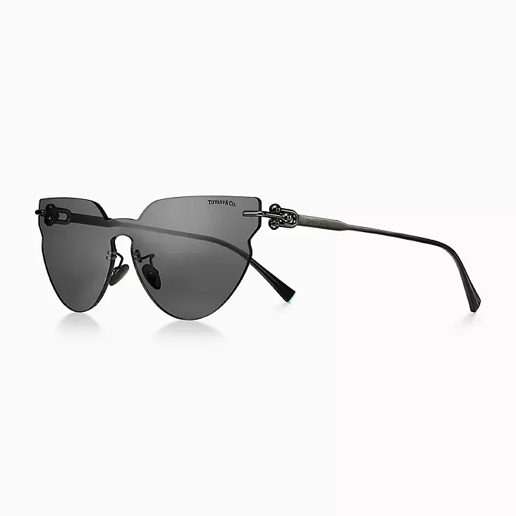 A pair of sunglasses with a heart shaped frame on a white background.