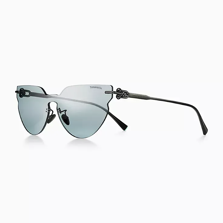 A pair of sunglasses with a black frame and blue lenses on a white background.