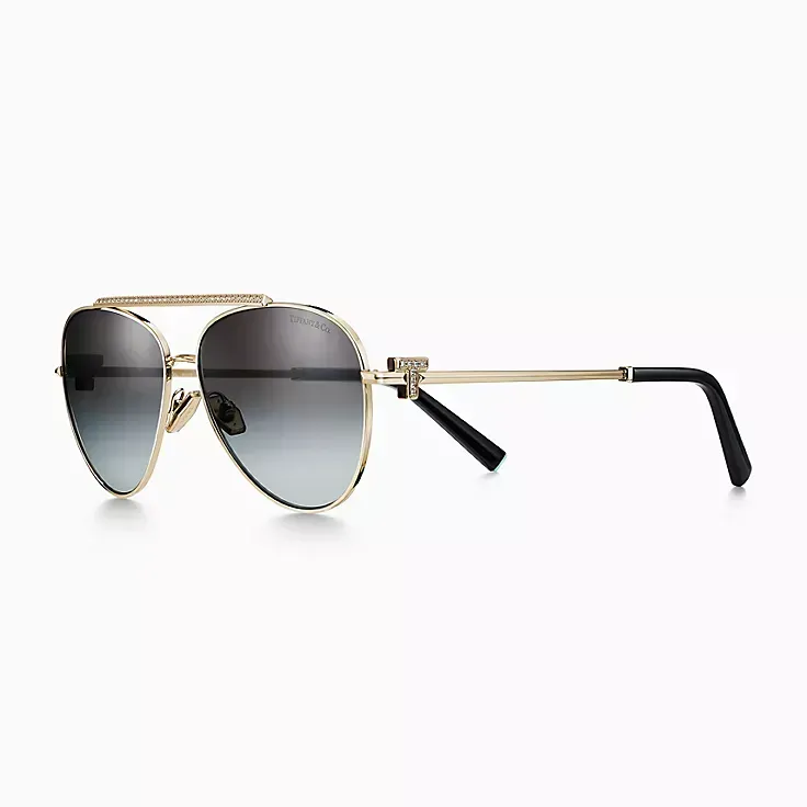 A pair of aviator sunglasses on a white background.