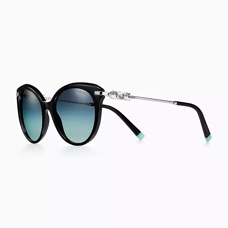 A pair of black sunglasses with blue lenses on a white background.