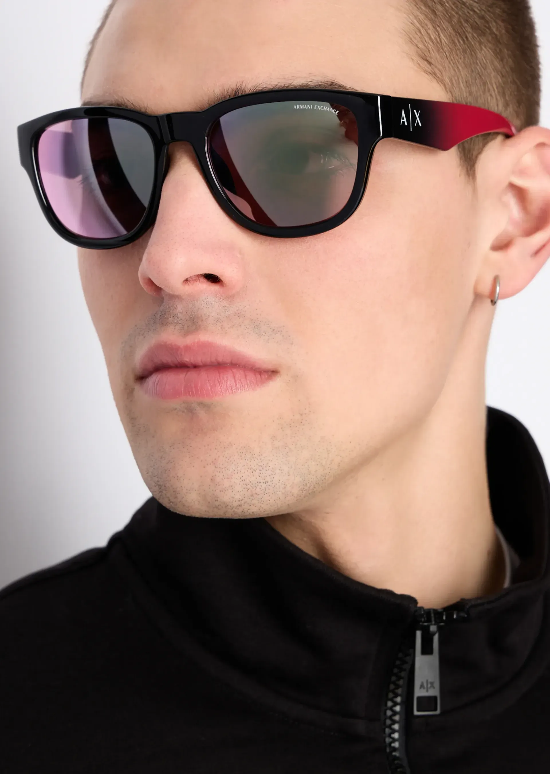 A close up of a man wearing sunglasses and a black jacket