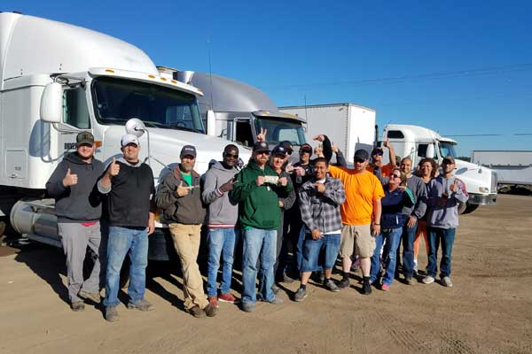cdl school students standing together happy about cdl school graduation