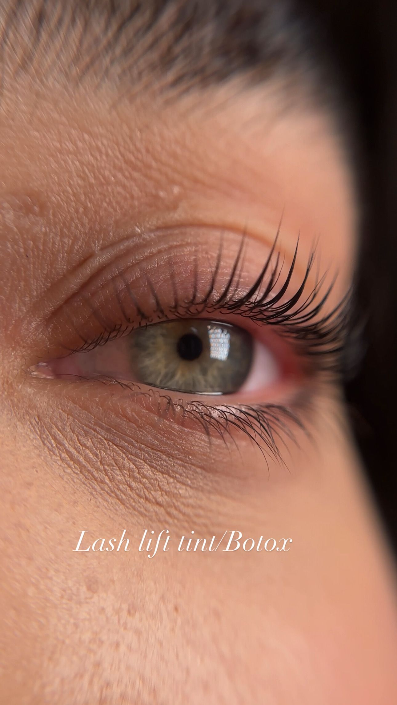A close up of a woman 's eye with long eyelashes.