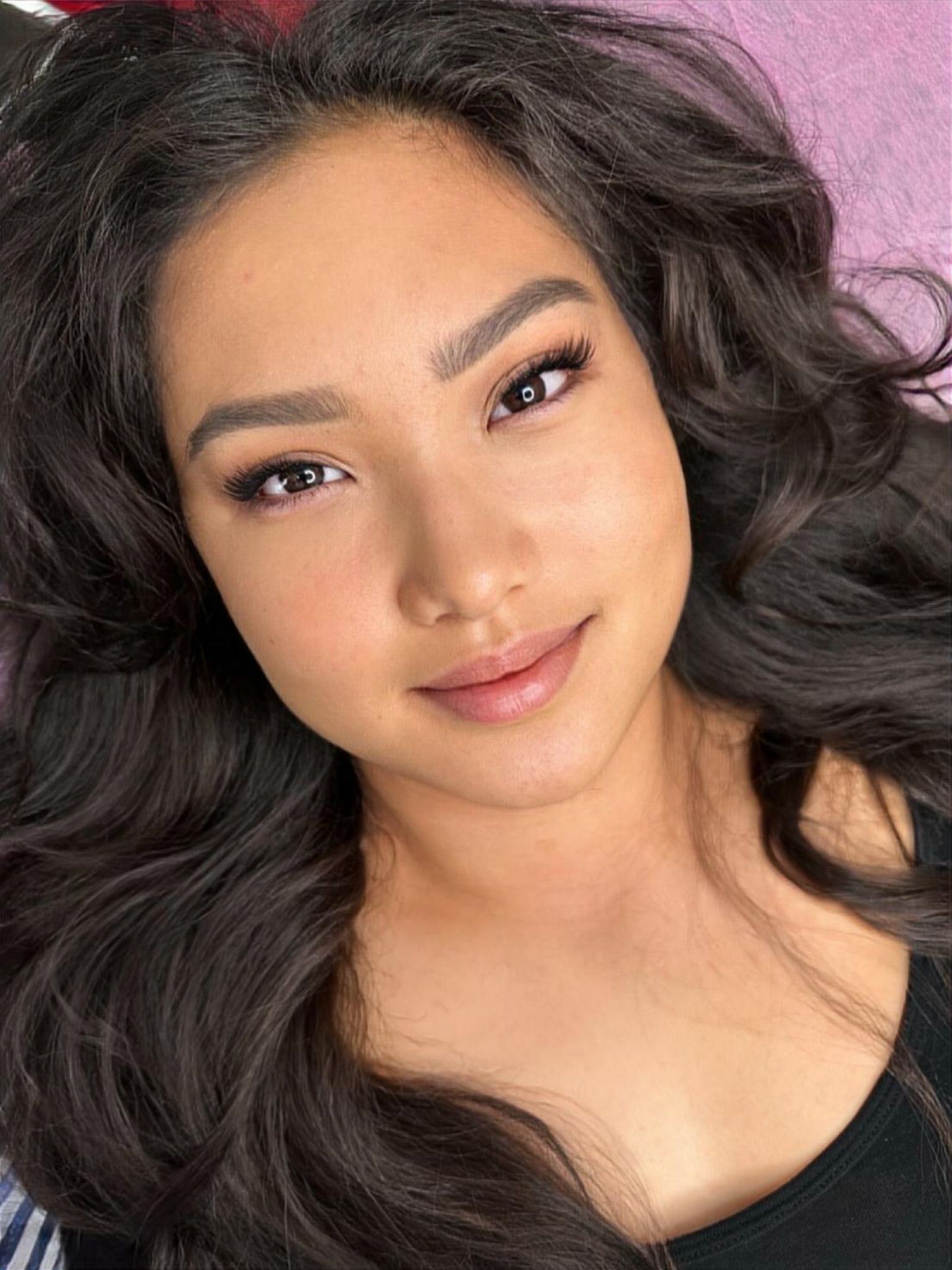 A close up of a woman 's face with long hair.