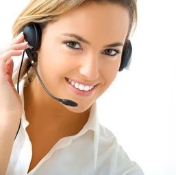 women in headset smiling A woman is wearing a headset and smiling.